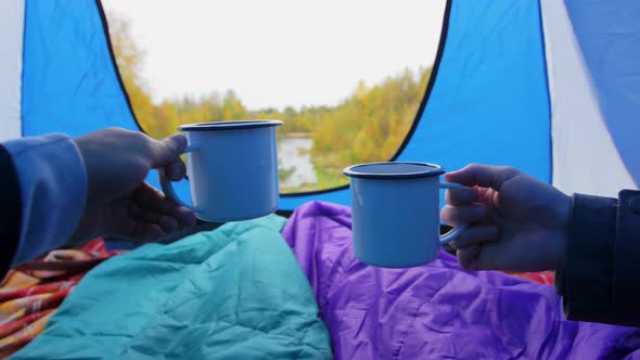 View From Camp Tent with Hands Toasting Tea Cups
