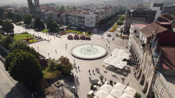 Inactive fountain in Republic square of Braga old town center, Portugal. Aerial orbit alt