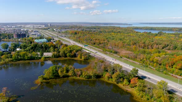 4K camera aerial drone view of Trans-Canada highway and fall season foliage colors in Montreal.