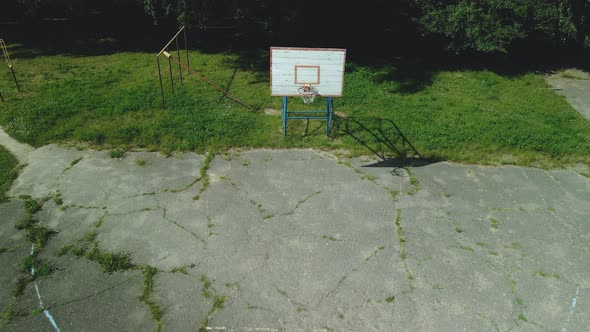 Old Basketball Backboard. Made From Boards. Peeling Paint And A Battered Basket alt