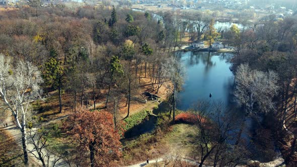 Arial Drone View Flight Over Lake in Park on Sunny Autumn Day alt