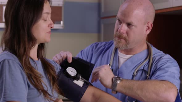 Male nurse check patient's blood pressure