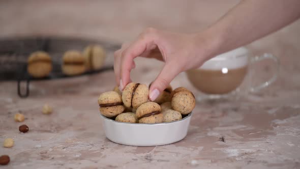 Baci Di Dama Homemade Italian Hazelnut Biscuits Cookies with Chocolate and Cup of Coffee