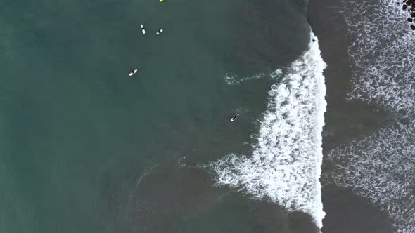 AERIAL: drone, surfer riding the waves, steady view alt