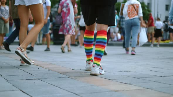 LGBTQ Pride Parade with Walking Activist in Rainbow Knee Socks and Sneakers