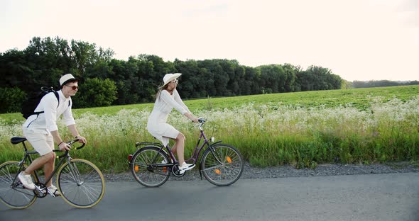 Young Couple Riding Bicycles in Countryside