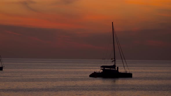 Silhouette of a Yacht at Sunset alt