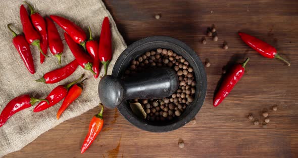 Peas of Black Pepper in a Mortar Slowly Rotates.  alt