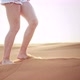 Closeup Beautiful Female Legs in Shorts Walking on Desert Sand - VideoHive Item for Sale