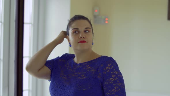 Fat Girl in a Blue Dress in Front of a Mirror alt