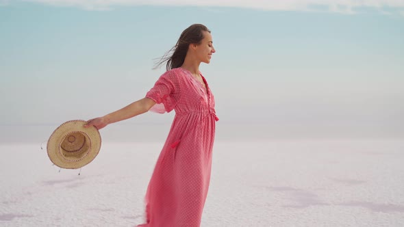 Freedom Woman in Pink Dress and Hat Carefree and Happy with Open Arms on Blue Sky White Salt Beach alt