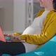 Side View Unrecognizable Pregnant Woman Using Laptop Sitting on Bag Chair Indoors - VideoHive Item for Sale