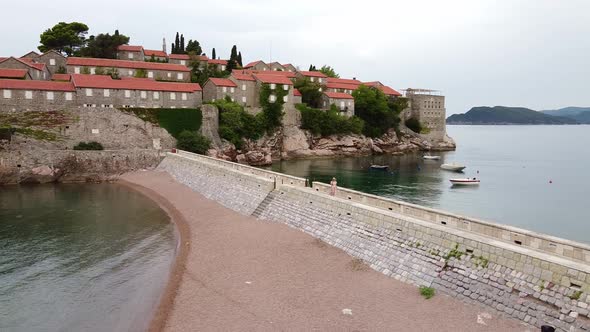 Aerial View of Settled Island and Stone Bridge Washed By Water From Both Sides alt
