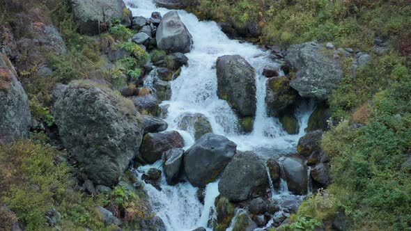 Waterfall flowing above the big boulders