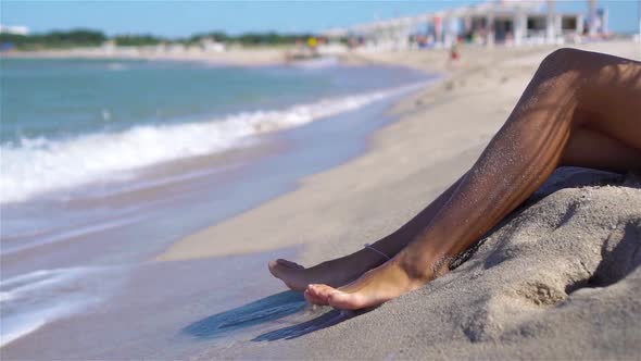 Woman Legs Closeup at Beach During Summer Vacation