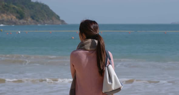Woman look at the sea at winter time alt