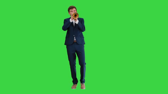 Man in Suit Standing Playing Trumpet on a Green Screen, Chroma Key. alt
