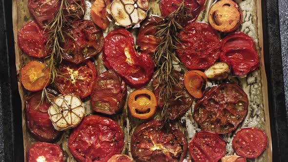 Various Kinds of Roasted Red and Yellow Tomatoes with Thyme and Garlic on an Metal Oven Tray