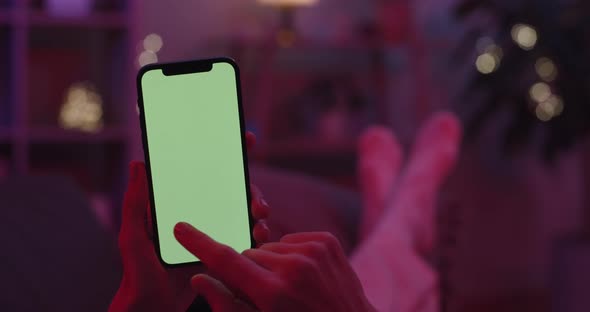 Woman Sliding with Forefinger on Green Screen of Mobile alt