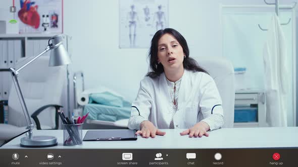 Woman Doctor Talking To Camera and Giving Online Medical Consultation alt