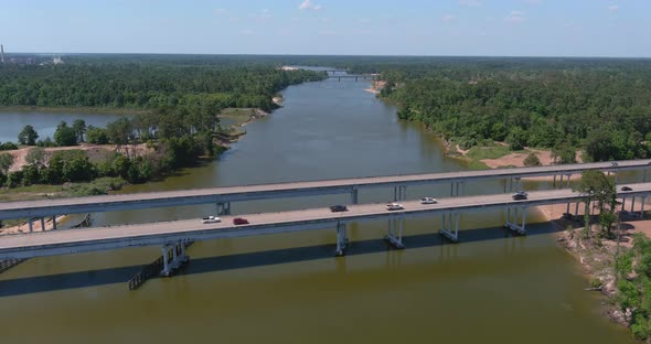Aerial of cars driving on bridge that crosses over the San Jacinto River in Houston, Texas alt