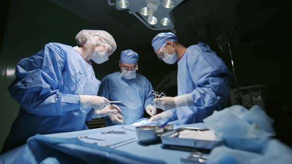 Surgeons Performing Operative Procedure on Patient alt