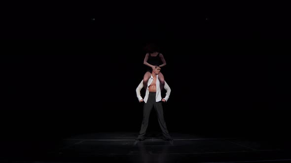 Woman Dancer Sits on Man's Shouldersmaking Synchronous Hand Movementsflipping Upside Downlying on