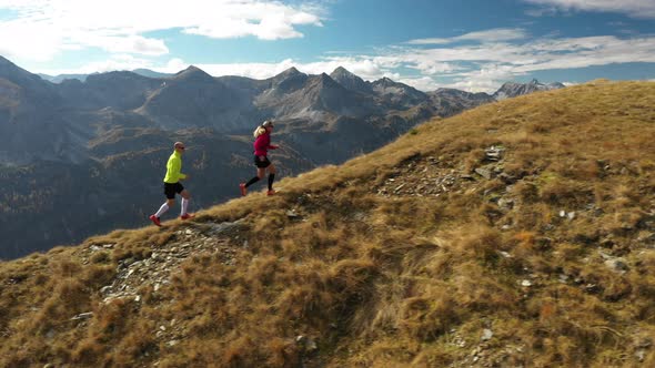 Aerial View Trail Running Couple in Mountains alt