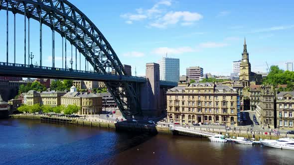 Arial footage of the Tyne bridge and Newcastle skyline in Newcastle Upon Tyne on a sunny day alt