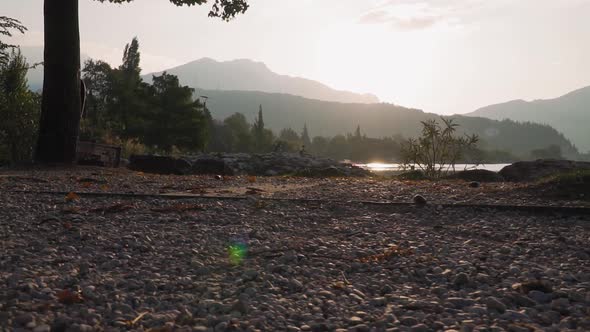 Trekking lakeside, morning mountain panorama, sunrise, shiny water of Lake Garda alt