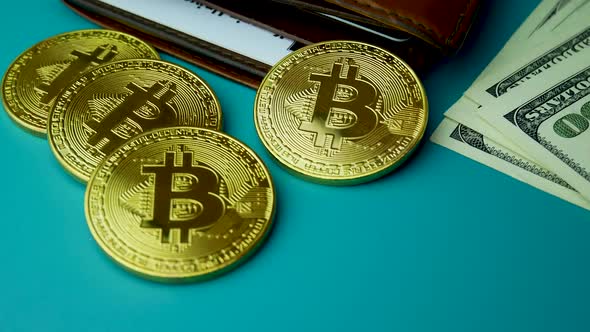 Gold Bitcoin BTC Coins on Bills of 100 Dollars