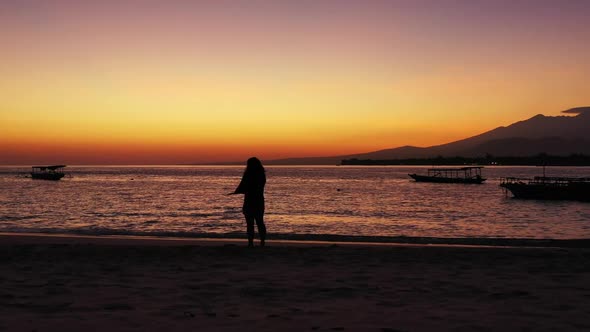 Female model happy and smiling on tranquil seashore beach adventure by clear sea and white sandy bac alt