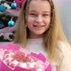 Teenage Child with a Bouquet of Sweets on the Background of a Christmas Tree - VideoHive Item for Sale