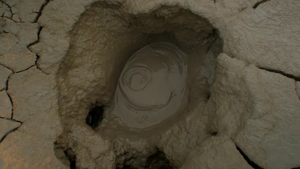 iceland nature, geothermal mud pot, camera movement, camera tracking dolly in a mudpot from wide to alt