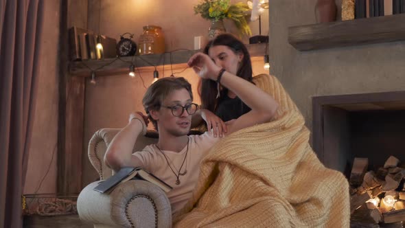 Close Up Cute Young Couple Smiling Hugging Sitting On A Chair alt