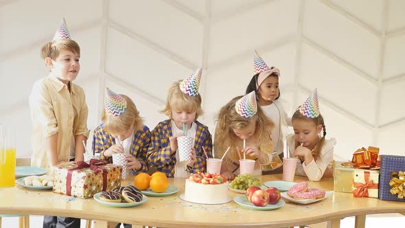 Group of Children Drinking Juice at Birthday Party alt