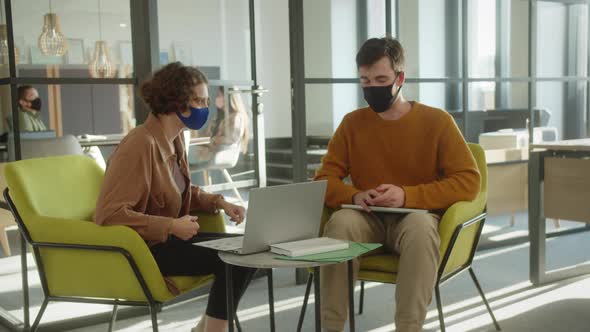 Two Students are Sitting Together in the Hall and Discussing About the Future Project They Should Do