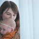 A Loving Mother and Child at the Window with Curtains - VideoHive Item for Sale