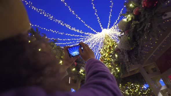 Lady in Beret Takes Picture of Christmas Tree at Winter Fair