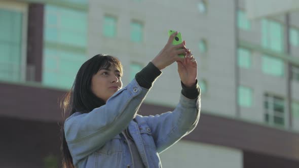 Cheerful Teen Girl Taking Selfie with Smartphone alt