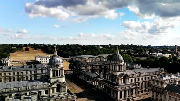 Aerial shot of the Old Naval College in Greenwich, London. Drone goes down towards the buildings. alt
