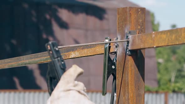 Slow Motion Closeup Worker Welds Fence Metal Carcass alt
