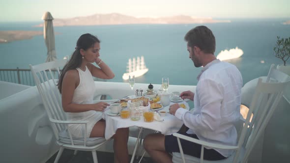 Couple on Honeymoon Having Breakfast Outside