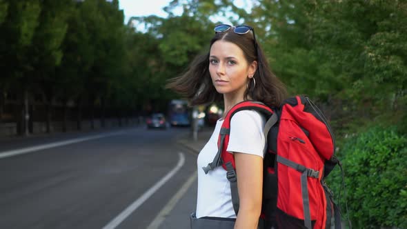 Female tourist with backpack alt
