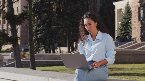Serious Young Attractive Female Freelancer Worker Sitting Terrace in City Building Background Typing alt