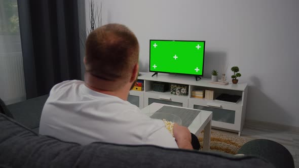 Watching Green Screen Chroma Key TV at home interior alt