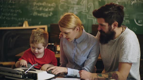 Early Childhood Education. Teachers Day. Family Studying. Parents Helping Child with Homework at alt