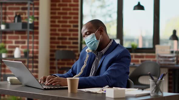Executive Assistant Talking to Manager on Landline Phone alt
