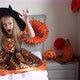Cute Caucasian Little Girl with Blonde Hair Seven Years Old in Witch Dress and Hat Having Fun and - VideoHive Item for Sale