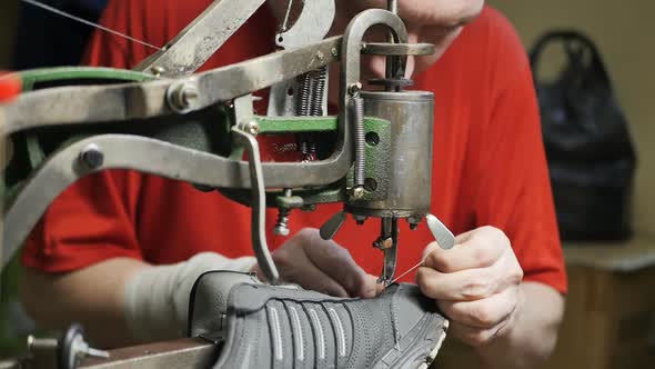 Shoe Maker Stitching the Seam of a Sneaker with an Old Mechanical Sewing Machine
